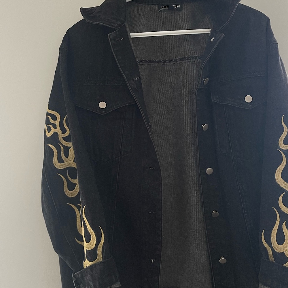 Black Fashion Nova denim jacket with gold flames on the sleeves. Size small